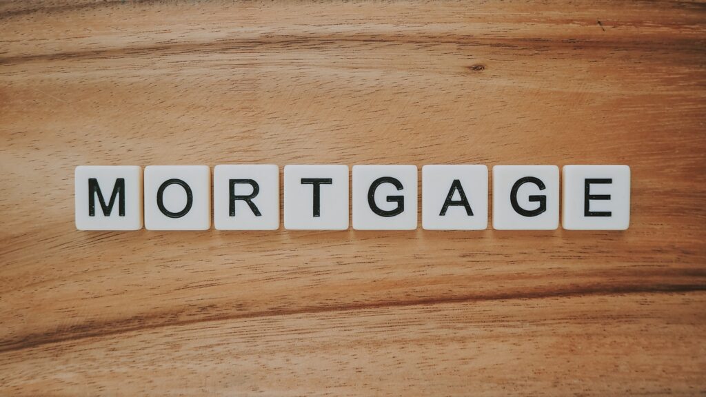 dicces with letters of the word mortgage on wooden surface