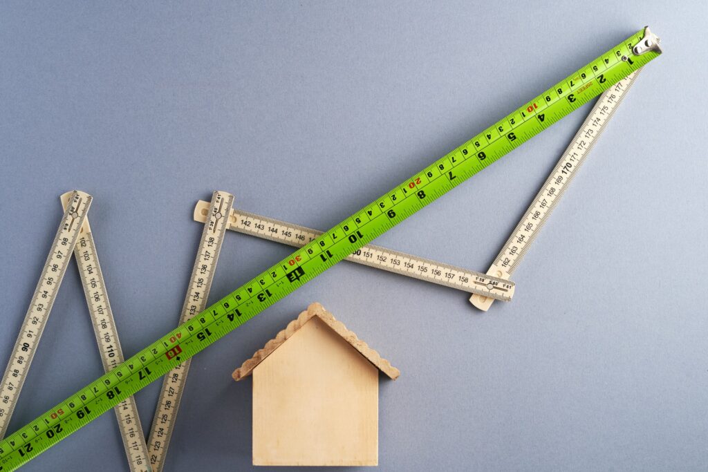 green ruler above a wooden shaped house measuring How Long Does an Appraisal Take