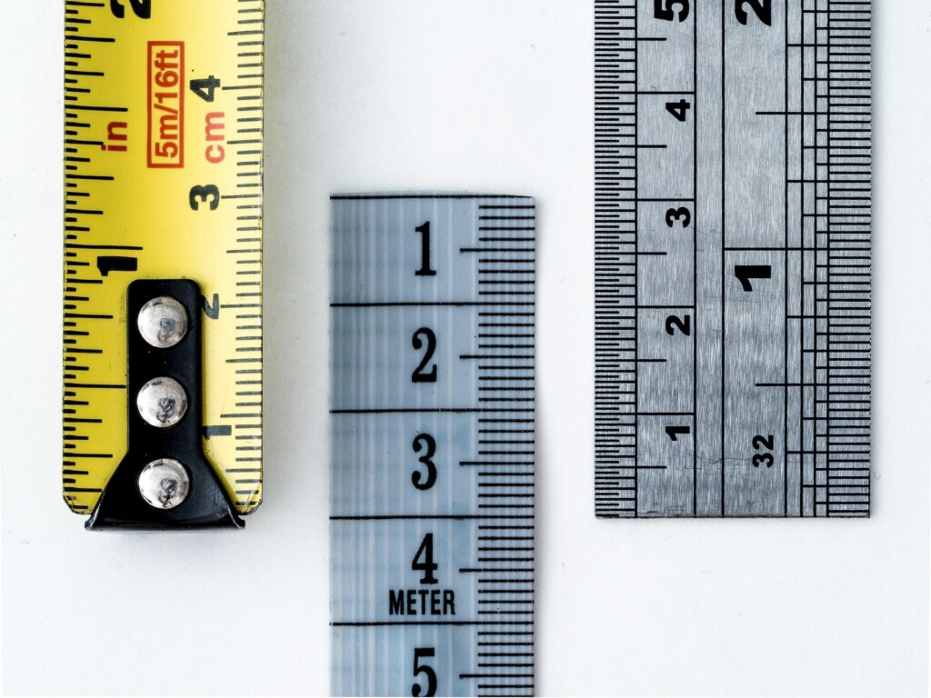 Macro of various tape measures and rulers symbolizing what is considered a good lot size